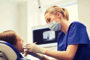 Dentist examines a person's mouth, representing tooth decay caused by Suboxone and the need for dental procedures